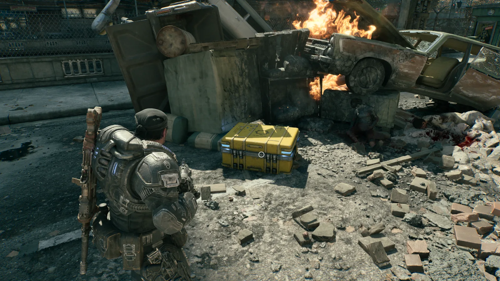 Yellow campaign Hard Case beside a burning wreck