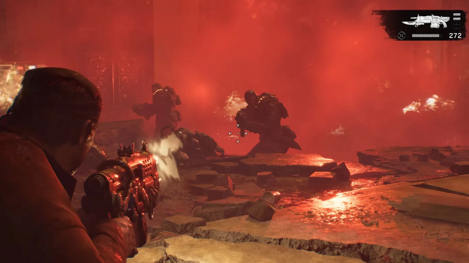 A COG soldier aims a distinctive weapon at Locust enemies in a red-lit E-Day battle.